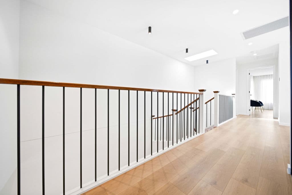 Wilton project — traditional staircase with timber treads and iron spindle balustrade, wide view