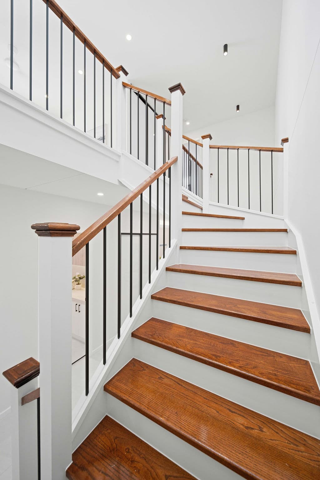 Wilton project — traditional staircase with timber treads and iron spindle balustrade, wide view