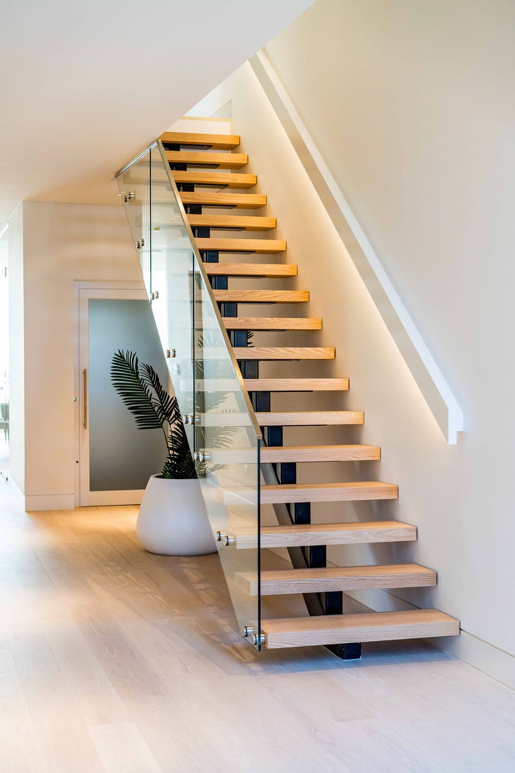 Cronulla project — floating staircase with oak treads and glass balustrade, view