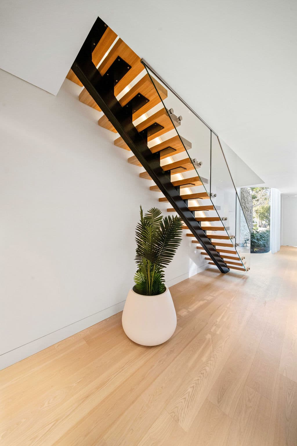 Cronulla project — floating staircase with oak treads and glass balustrade, wide view