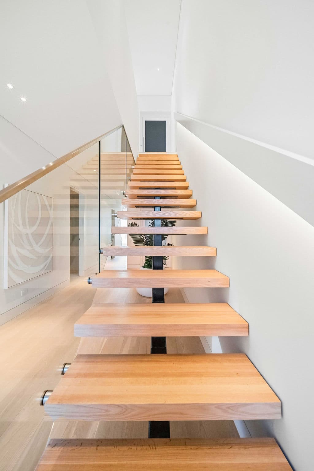 Cronulla project — floating staircase with oak treads and glass balustrade, wide view